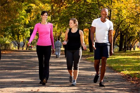 Three people walking in a park, getting some exercise Stock Photo - Budget Royalty-Free & Subscription, Code: 400-04149632