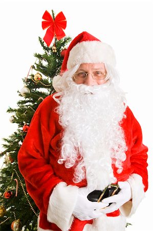 simsearch:400-04636742,k - Portrait of jolly Santa Claus in front of a Christmas tree.  White background. Foto de stock - Royalty-Free Super Valor e Assinatura, Número: 400-04149809