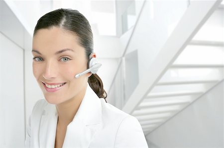 simsearch:400-04472832,k - Headset phone business woman dress in white indoor modern office stair Stock Photo - Budget Royalty-Free & Subscription, Code: 400-04140582