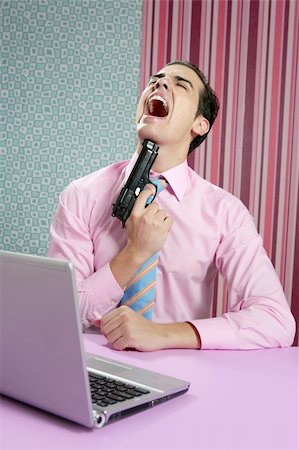 businessman young shooting handgun with computer pink bacground Stock Photo - Budget Royalty-Free & Subscription, Code: 400-04140622