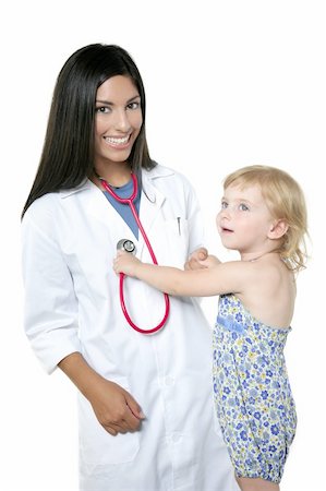 Brunette pediatric doctor with blond little girl on medical exam Foto de stock - Super Valor sin royalties y Suscripción, Código: 400-04140642