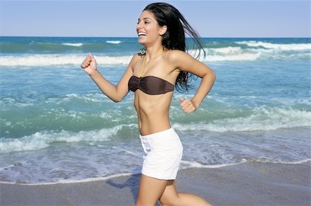 simsearch:400-04123668,k - Beautiful summer indian brunette girl jumping on the blue beach Stock Photo - Budget Royalty-Free & Subscription, Code: 400-04140670