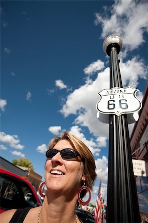 simsearch:400-07955646,k - Woman on side of route in front of Route 66 sign Stock Photo - Budget Royalty-Free & Subscription, Code: 400-04141157