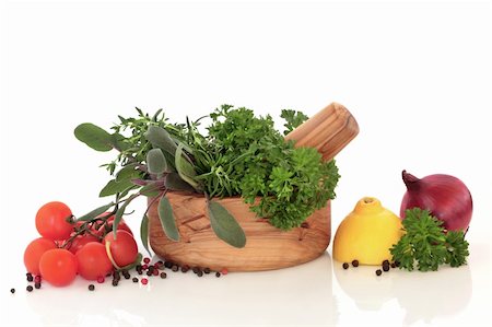 simsearch:400-04846756,k - Herb leaf selection in an olive wood mortar and pestle, with lemons, red onion halves, tomatoes on the vine and peppercorns, over white background. Stock Photo - Budget Royalty-Free & Subscription, Code: 400-04141307