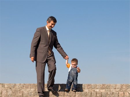 sergiyn (artist) - a father and his little son are walking outdoors Foto de stock - Super Valor sin royalties y Suscripción, Código: 400-04141469