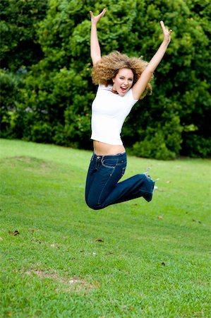 eastwestimaging (artist) - A teenage girl jumping in the park Foto de stock - Super Valor sin royalties y Suscripción, Código: 400-04143589