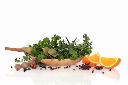 simsearch:400-06365740,k - Herb leaf and spice selection with an olive wood bowl and two orange halves over white background with reflection. Stockbilder - Microstock & Abonnement, Bildnummer: 400-04154044