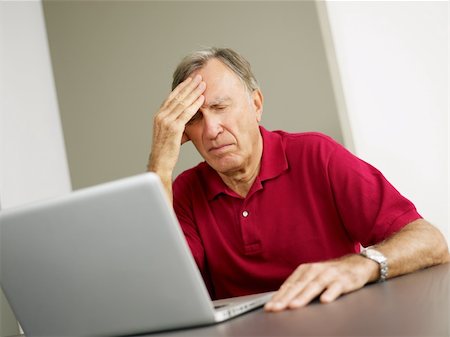 simsearch:640-01362711,k - Senior man having headache while using laptop. Copy space Photographie de stock - Aubaine LD & Abonnement, Code: 400-04154136