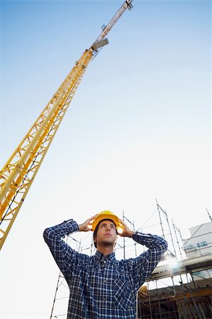 construction worker wearing hard hat. Low angle view, copy space Stock Photo - Budget Royalty-Free & Subscription, Code: 400-04154147