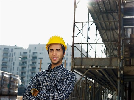 Construction worker with arms folded looking at camera. Copy space Stock Photo - Budget Royalty-Free & Subscription, Code: 400-04154148