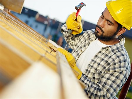 roof hammer - latin american construction worker on house roof with hammer. Copy space Stock Photo - Budget Royalty-Free & Subscription, Code: 400-04154142