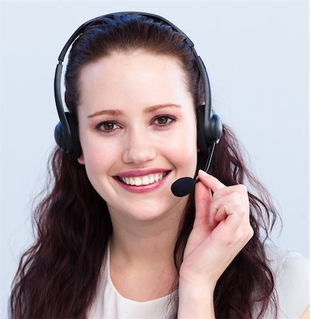 simsearch:400-03990860,k - Portrait of smiling beautiful young woman with a headset on Photographie de stock - Aubaine LD & Abonnement, Code: 400-04154724