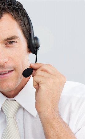 simsearch:400-03990860,k - Close-up of an attractive businessman working in a call center with a headset on Photographie de stock - Aubaine LD & Abonnement, Code: 400-04154736