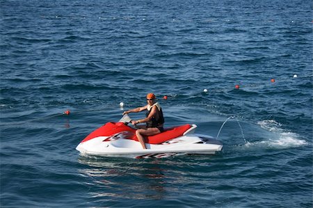 An adult man on a wave runner at sea Stockbilder - Microstock & Abonnement, Bildnummer: 400-04155220