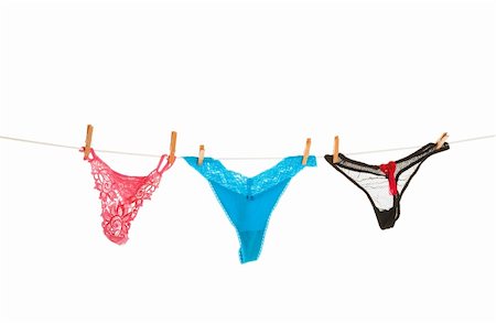 Fashion intimates hung on the clothes line to dry.  Shot on white background. Stock Photo - Budget Royalty-Free & Subscription, Code: 400-04155601