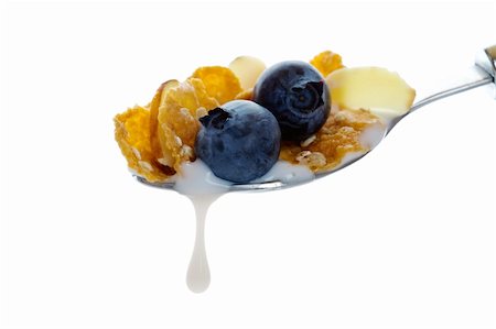 Hearty oat and wheat flake cereal with crunchy almonds and fresh blueberries.  Shot on white background. Foto de stock - Super Valor sin royalties y Suscripción, Código: 400-04155885