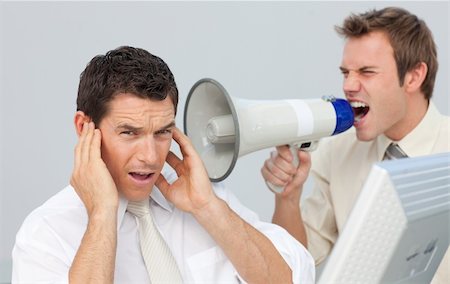 Businessman yelling through a megaphone at his colleague in the office Stock Photo - Budget Royalty-Free & Subscription, Code: 400-04156378