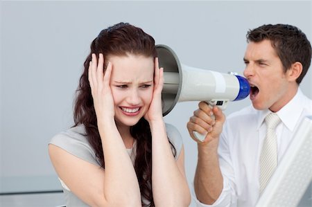 simsearch:400-09223567,k - Businessman yelling through a megaphone at a businesswoman in the office Stock Photo - Budget Royalty-Free & Subscription, Code: 400-04156379