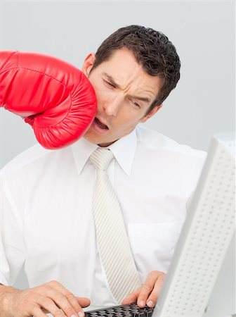 phone with pain - A businessman being boxed in his face while he is working in the office Stock Photo - Budget Royalty-Free & Subscription, Code: 400-04156373