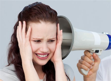 simsearch:400-09223567,k - Portrait of a businesswoman getting nervous with a megaphone next to her Stock Photo - Budget Royalty-Free & Subscription, Code: 400-04156380