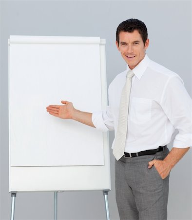 professionals whiteboard - Confident businessman giving a presentation in the office Stock Photo - Budget Royalty-Free & Subscription, Code: 400-04156449