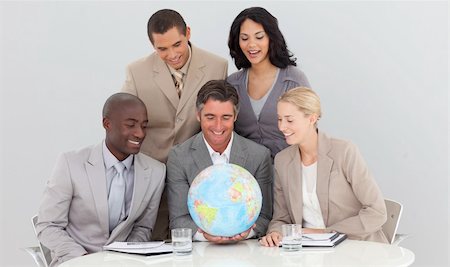 simsearch:400-04187718,k - Multi-ethnic business team holding a terrestrial globe in the office Foto de stock - Royalty-Free Super Valor e Assinatura, Número: 400-04156462