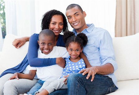 Portrait of a Smiling Afro-american family on the sofa Stock Photo - Budget Royalty-Free & Subscription, Code: 400-04156677