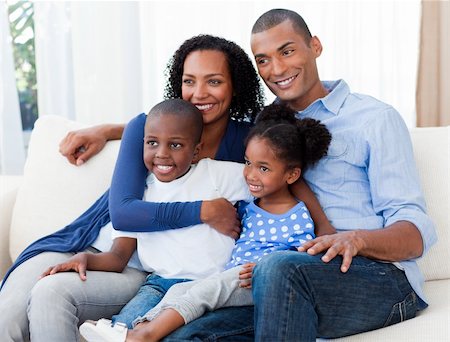 Portrait of a happy Afro-american family on the sofa Stock Photo - Budget Royalty-Free & Subscription, Code: 400-04156678