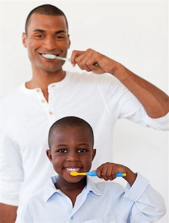 Father and his son brushing their teeth in the bathroom Stock Photo - Budget Royalty-Free & Subscription, Code: 400-04156701