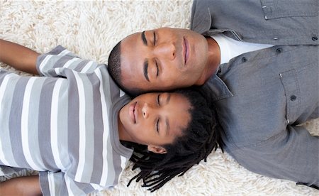 Afro-American father and son sleeping on the floor at home Stock Photo - Budget Royalty-Free & Subscription, Code: 400-04156719