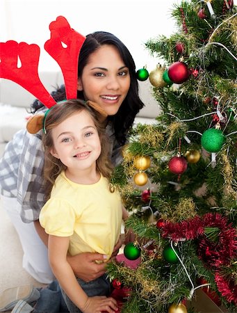Mother and daughter decorating a Christmas tree at home Stock Photo - Budget Royalty-Free & Subscription, Code: 400-04156786