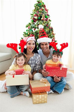 Family decorating a Christmas tree at home Stock Photo - Budget Royalty-Free & Subscription, Code: 400-04156791