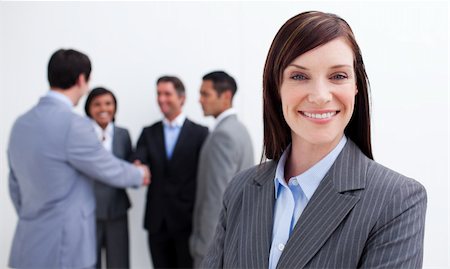 simsearch:400-06567931,k - Smiling female executive with her team in the background. Business concept. Stock Photo - Budget Royalty-Free & Subscription, Code: 400-04157236