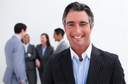 simsearch:400-06567931,k - Smiling businessman leading her team agaisnt white background Stock Photo - Budget Royalty-Free & Subscription, Code: 400-04157242