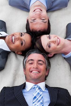 Manager and his team lying on the floor with heads together Stock Photo - Budget Royalty-Free & Subscription, Code: 400-04157276