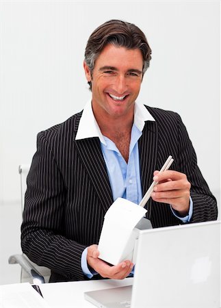 simsearch:689-03124356,k - Portrait of a smiling businessman eating chines food at work Stock Photo - Budget Royalty-Free & Subscription, Code: 400-04157312