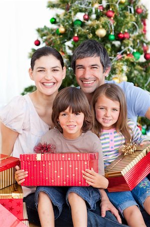 Happy family having fun with Christmas presents Stock Photo - Budget Royalty-Free & Subscription, Code: 400-04157458