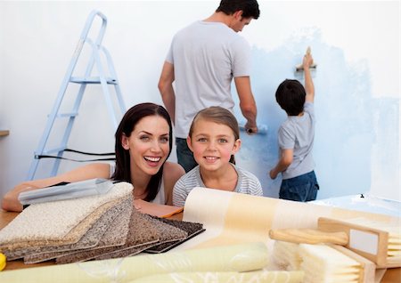 Happy young family doing up their new home Stock Photo - Budget Royalty-Free & Subscription, Code: 400-04157498