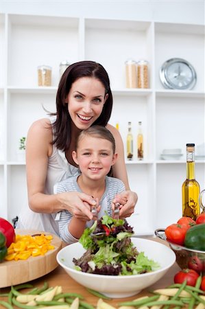 Happy mother and her girl preparing a salad in the kitchen Stock Photo - Budget Royalty-Free & Subscription, Code: 400-04157541