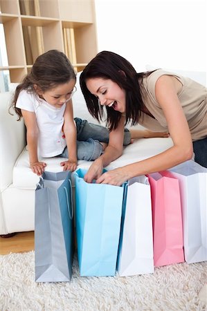 simsearch:400-04323202,k - Happy Mother and daughter unpacking shopping bags in the living-room Stock Photo - Budget Royalty-Free & Subscription, Code: 400-04157550