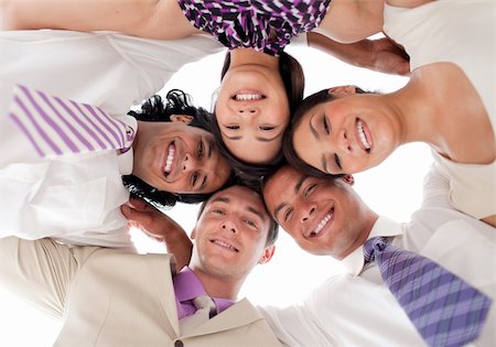 Smiling business team in a circle with heads together against white background Stock Photo - Budget Royalty-Free & Subscription, Code: 400-04157663