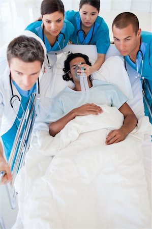 resuscitation hospital - Multi-ethnic emergency team carrying a patient. Medical concept. Stock Photo - Budget Royalty-Free & Subscription, Code: 400-04157725