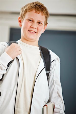 Teenage boy outside classroom with books and backpack Stock Photo - Budget Royalty-Free & Subscription, Code: 400-04158429