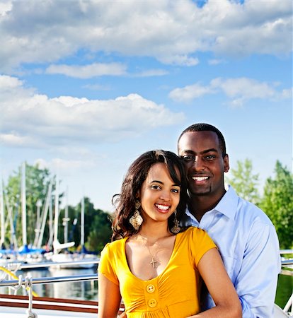 Portrait of young romantic couple standing at harbor with copyspace Stock Photo - Budget Royalty-Free & Subscription, Code: 400-04158547