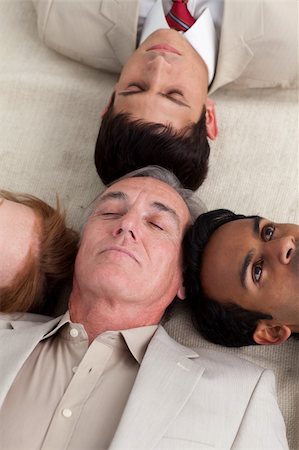International business team lying on the floor with heads together Stock Photo - Budget Royalty-Free & Subscription, Code: 400-04159674