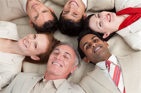 Business team lying on the floor with heads together Stock Photo - Budget Royalty-Free & Subscription, Code: 400-04159677