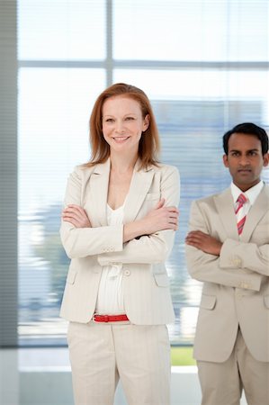 simsearch:400-04097612,k - Businessman with folded arms standing with her colleague in the background Fotografie stock - Microstock e Abbonamento, Codice: 400-04159735