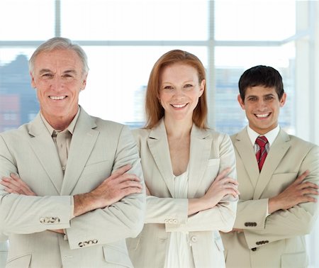 simsearch:400-05118165,k - Business team with folded arms in a line smiling at the camera Foto de stock - Royalty-Free Super Valor e Assinatura, Número: 400-04159744
