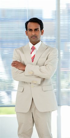 simsearch:400-05118165,k - Confident ethnic businessman with folded arms in a business building Stock Photo - Budget Royalty-Free & Subscription, Code: 400-04159749