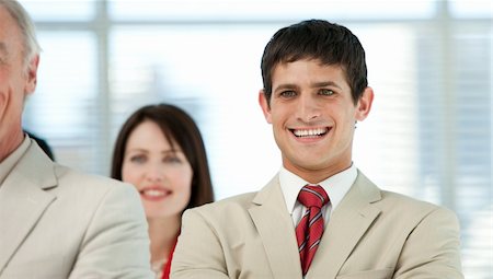 simsearch:400-04097612,k - Smiling young businessman with his colleagues in a business building Fotografie stock - Microstock e Abbonamento, Codice: 400-04159740